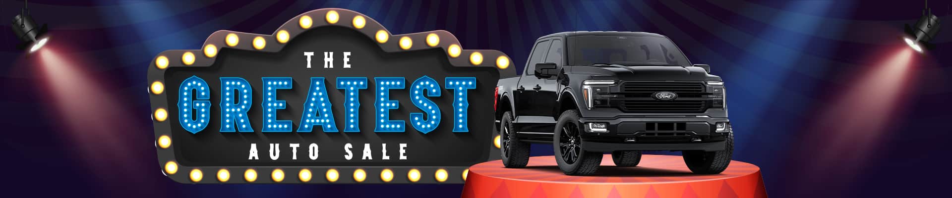 Spotlit sign reads "The Greatest Auto Sale" beside a black truck on a red pedestal.