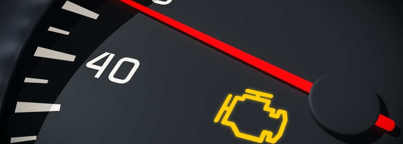 Dashboard with an engine warning light and speedometer reading 40.