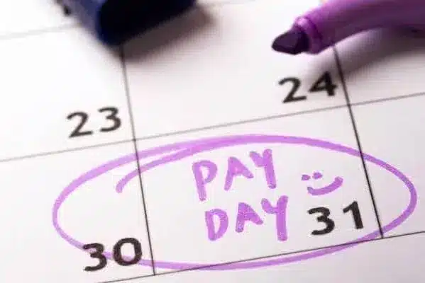 Calendar with "Pay Day" circled on the 31st in purple, marked with a smiley face.