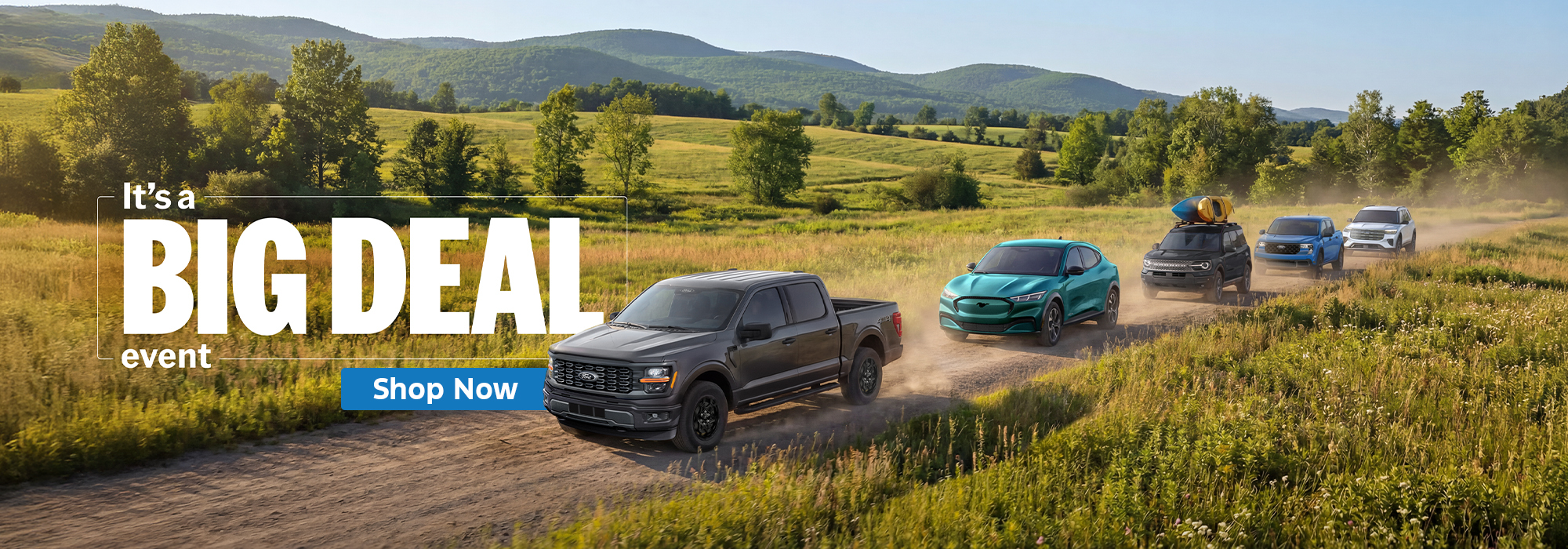 SUVs and trucks driving on a rural road under blue skies, "Big Deal Event" text overlay, with "Shop Now" button.